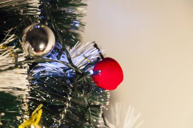 Close-up of balls on the Christmas tree with neutral background. Brazilian Christmas. Tree decoration. New year concept. Tree concept.	