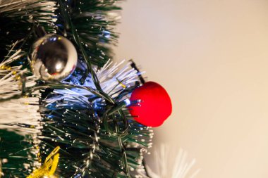 Close-up of balls on the Christmas tree with neutral background. Brazilian Christmas. Tree decoration. New year concept. Tree concept.	