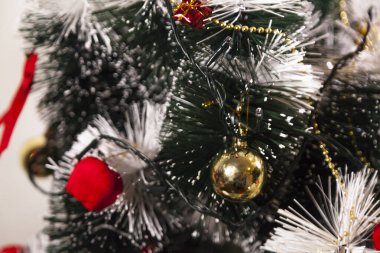Close-up on the Christmas tree with neutral background. Brazilian Christmas. Tree decoration. New year concept. Tree concept.	