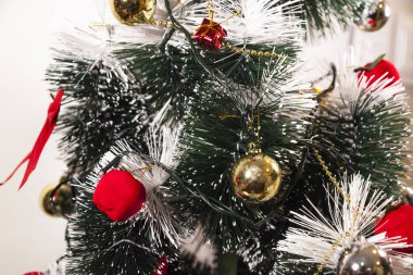 Close-up on the Christmas tree with neutral background. Brazilian Christmas. Tree decoration. New year concept. Tree concept.	