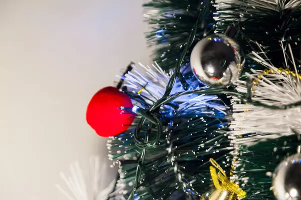 Close-up of balls on the Christmas tree with neutral background. Brazilian Christmas. Tree decoration. New year concept. Tree concept.	