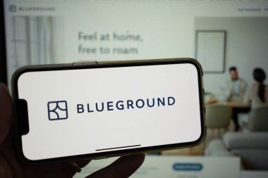 Roosendaal, The Netherlands - February 2, 2025: Person holding a mobile phone displaying the logo of Blueground, a real estate tech company based in Barcelona, Spain. clipart