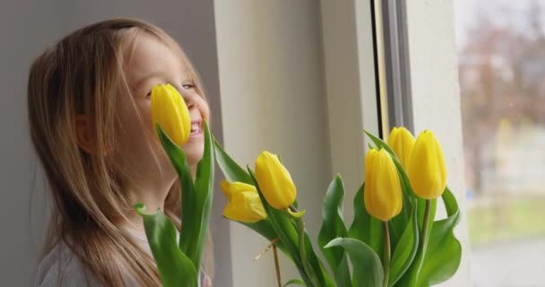 Little Girl Rejoices Hugs Bouquet Yellow Tulips Her Hand Concept — Stock Video