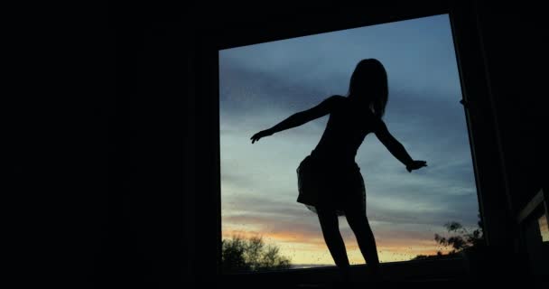 Silhouette Little Girl Dances Background Window Covered Raindrops Sunset — Stock Video