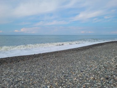 Deniz kıyısı, güzel dalgalar, köpük ve kum.