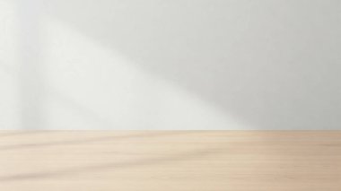 Temiz ve minimalist bir düzenek. Hafif ahşap bir masa ve düz beyaz bir duvar arka planı var.