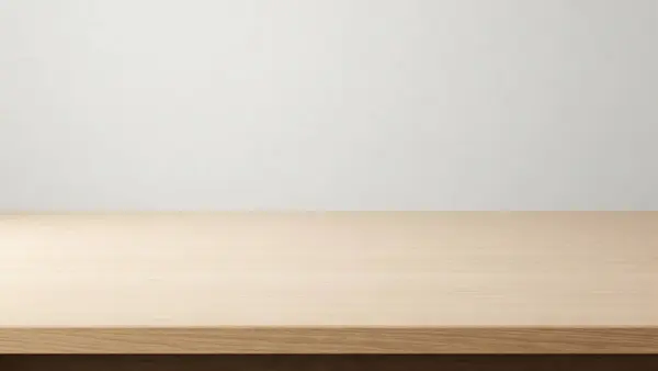 Temiz ve minimalist bir düzenek. Hafif ahşap bir masa ve düz beyaz bir duvar arka planı var.
