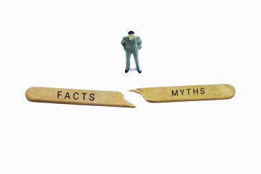 Miniature Figure Standing Between Broken Sticks Representing Facts Versus MythsMiniature Figure Standing Between Broken Sticks Representing Facts Versus Myths clipart