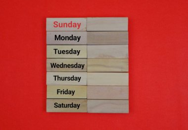 Wood Block Parlak Kırmızı Arkaplanda Haftanın Günleri listesini gösteriyor. metin için boşluk kopyala