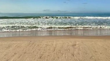 Yumuşak deniz kumlu bir sahilde rahatlatıcı dalgalar. Yüksek kalite 4k görüntü