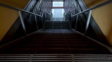 Şık metal parmaklıklar ve geometrik çizgilerle modern bir merdiven manzarası.