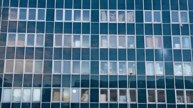 Bu çağdaş ofis binası çarpıcı bir cam cephe ile övünüyor ve çarpıcı yansımaları mükemmel bir şekilde yakalıyor.