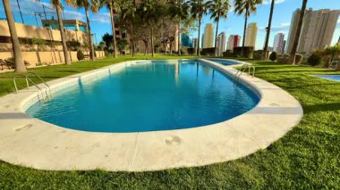 Yeşillik ve modern mimari ile çevrili nefes kesici bir havuz, rahatlama ve gençleştirme için mükemmel.