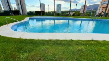 Serin ve sakin bir havuz yemyeşil bir ortamda, çarpıcı bir şehir silüeti, rahatlamak için mükemmel.