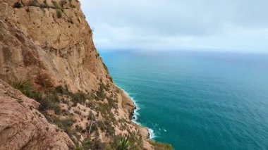 Çarpıcı bir panoramik manzaranın tadını çıkar dramatik bir kıyı şeridinin dingin okyanusla güzel bulutların altında buluşmasının.
