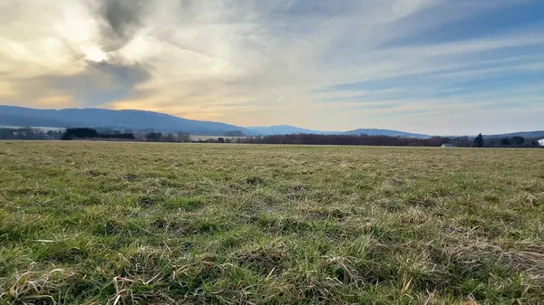 Nefes kesen sakin bir manzara geniş açık araziler ve bulutlu bir gökyüzünün altındaki güzel resimli tepeler.