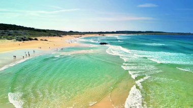 Canlı turkuaz sular ve yumuşak altın kumlarla övünen nefes kesici bir plajın tadını çıkarın.