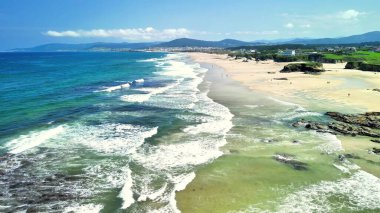 Bu büyüleyici hava görüntüsü, berrak mavi gökyüzünün altında nefes kesici plajları ve nazik okyanus dalgalarını çok güzel sergiliyor.