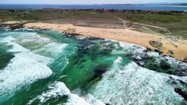 Sakin sahillere çarpan canlı kıyı dalgalarının nefes kesici ve çarpıcı hava görüntülerini tecrübe edin.