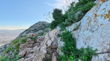 Güvenliğiniz için yemyeşil bir zincire sahip nefes kesici dağ yolu manzarasının keyfini çıkarın.