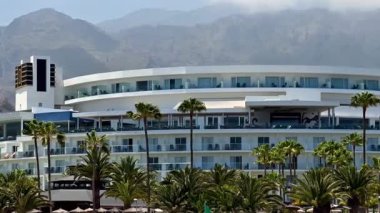 Palmiye ağaçları ve dağ manzaraları arasında nefes kesici lüks bir otel. Tatilciler için mükemmel bir konfor ve zarafet.