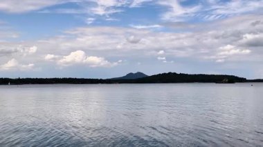 Huzurlu bir göl manzarası görkemli dağlar ve nefes kesici bulutlar, rahatlama ve huzur için mükemmel.