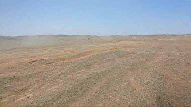 Gobi Çölü 'nde dört nala giden motosiklet sürücülerinin videosu.