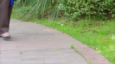 Two women stalking, close-up of legs