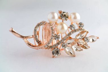 Yapraktan esinlenerek dizayn edilmiş, yuvarlak ve Markiz kesimi saf elmaslı, altın bir gül yüzüğünün yakın çekimi. Ayrıntılı, parlak ve temiz beyaz arka planda zarif..