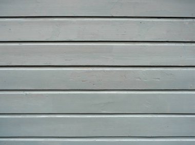 Temiz yapısı ve minimalist tasarımı olan gri ahşap bir duvar. Zamansız estetik tasarım projeleri için çok yönlü ilham sunuyor. Metinler için boşluk