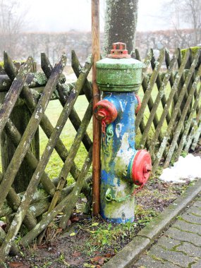 Colorful fire hydrant in the street. Creative color design makes this technical object eye-catching and attractive for urban design concepts and planning. clipart