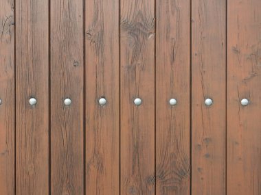Temiz yapısı ve minimalist tasarımı olan kahverengi ahşap bir duvar. Zamansız estetik tasarım projeleri için çok yönlü ilham sunuyor. Metinler için boşluk.