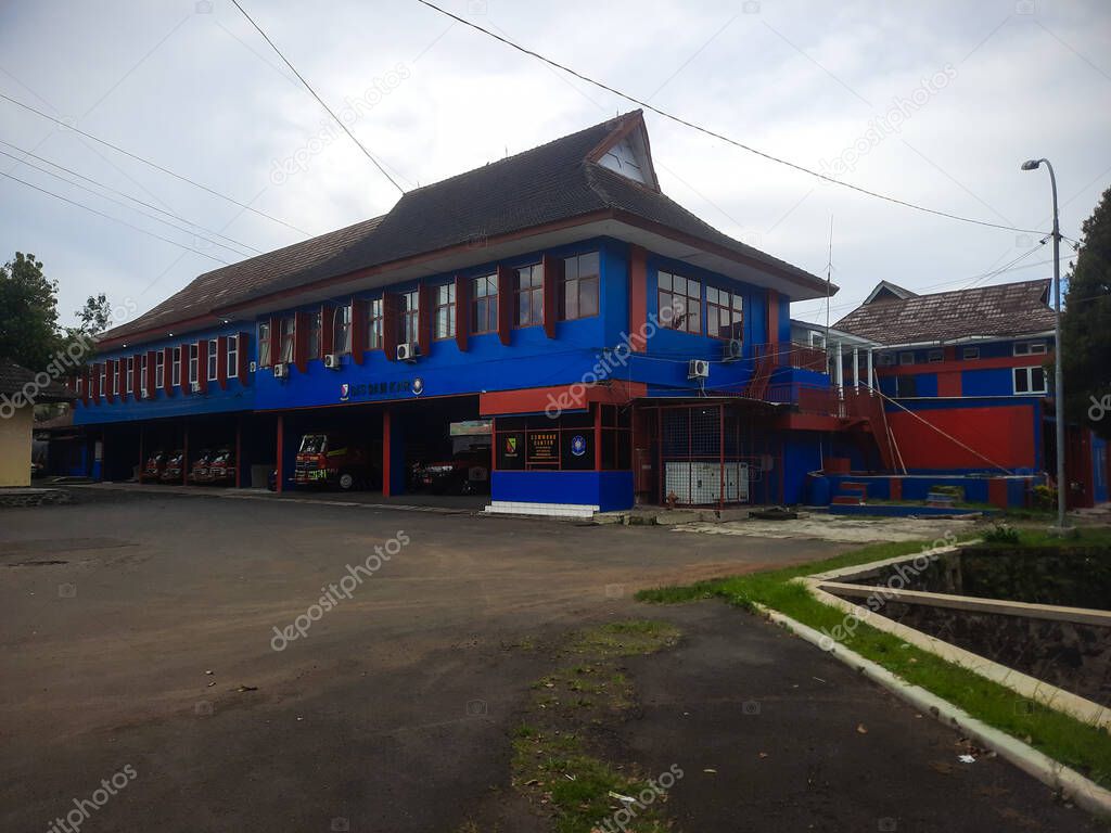 Bandung, indonesia - may 18, 2025 : The red and blue Fire Department building with a fire engine garage at the bottom.