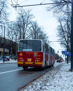 Lublin, Polonya - 01 14 2024: Red Ikarus 280.26 (1985) şehir caddesinden geçen eklemli otobüs.
