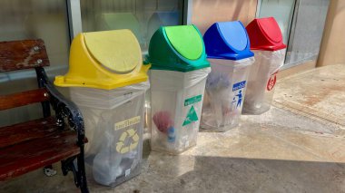 Tayland, 23 Mart 2025 - Çöp tenekelerinde çöp, vektör simgeleriyle sıralanmış çöp kutuları. (plastik, kağıt, metal, cam). Çöpleri materyal ve tiplere göre sıralıyorum. Çevre koruma, ekoloji.