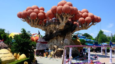 Mavi Gökyüzüne karşı kırmızı kürelerle Ağaç Şeklinde Eğlence Gezintisi