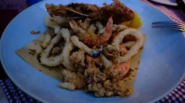 Restoranda tabakta kızarmış kalamar ve karides.