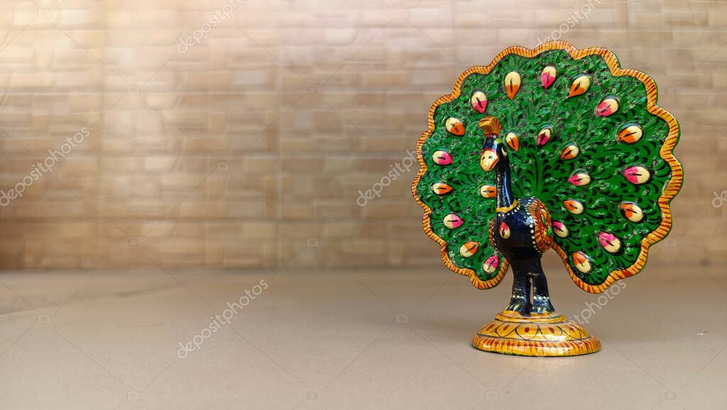 A peacock idol for the show piece with various color painting and feathers expanded. peacock symbol. peacock logo.