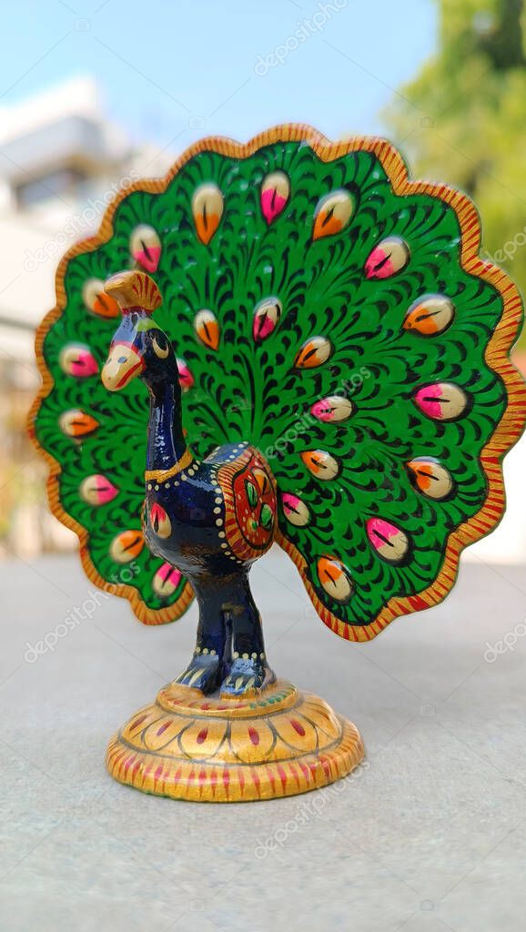 A peacock idol for the show piece with various color painting and feathers expanded. peacock symbol. peacock logo.