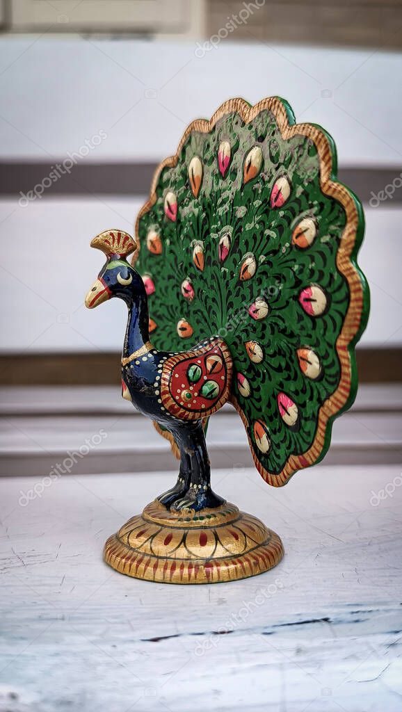 A peacock idol for the show piece with various color painting and feathers expanded. peacock symbol. peacock logo.