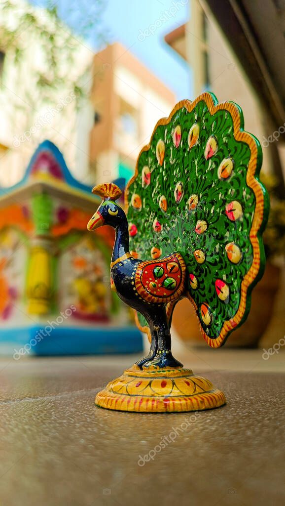 A peacock idol for the show piece with various color painting and feathers expanded. peacock symbol. peacock logo.