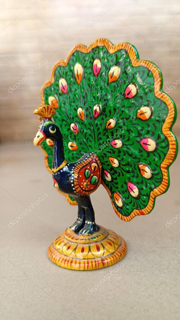 A peacock idol for the show piece with various color painting and feathers expanded. peacock symbol. peacock logo.