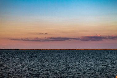 Denizde gün batımı, gökyüzü ve bulutlar
