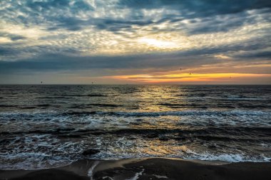 Gün batımında deniz kıyısında. Deniz kıyısında güzel bir gün batımı.