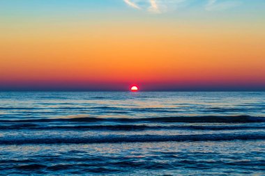Denizin üstünde gün batımı.