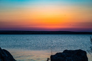 Su üstünde renkli günbatımı