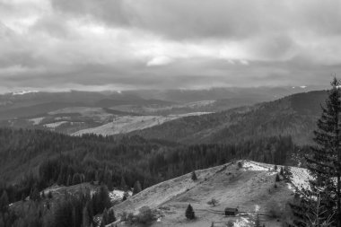 bulutlu bir gökyüzü ile güzel bir dağ manzarasının siyah ve beyaz fotoğrafı