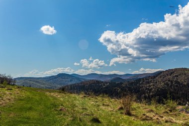 Yeşil tepeleri ve mavi gökyüzü olan güzel dağ manzarası