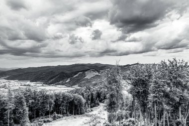 Dağların üzerinde siyah beyaz bulutlar