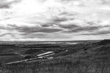 Dağların üzerinde siyah beyaz bulutlar